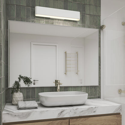 Modern bathroom with a rectangular mirror above a marble countertop, oval sink, and gold faucet. Green tile wall features the Willow LED Vanity 3CCT Light above the sink, next to a towel and a small potted plant.