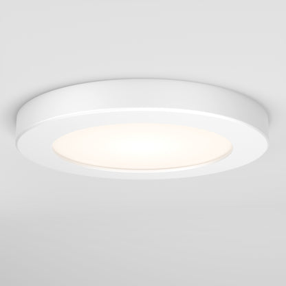 The Skylight Pro 5 3K LED Flat Panel Light is a modern, round, white fixture mounted flush to the ceiling, providing a soft, diffused glow.
