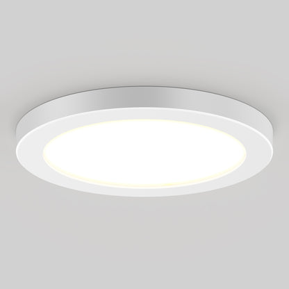 The 7" LED Skylight with 3 colour trim rings, featuring a modern, minimalistic design and adjustable colour-balance, is mounted on a light gray ceiling and brightly illuminates the room.