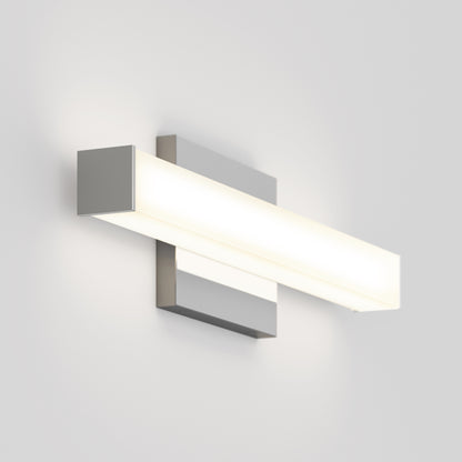 The Mylo LED Vanity Light 16IN is a modern, rectangular wall-mounted fixture featuring a brushed metal base and frosted white panel, emitting a soft glow against a plain white wall.