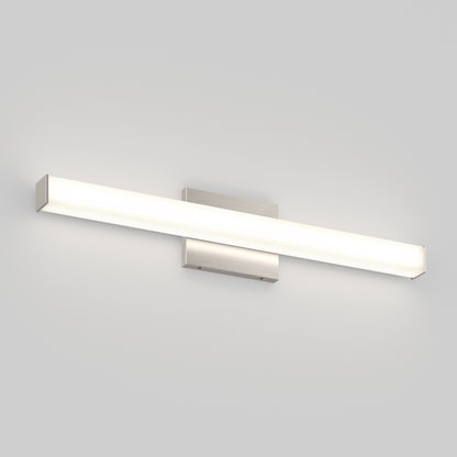 The Mylo LED Vanity Light 24IN features a modern rectangular design with a brushed metal base and a long frosted diffuser, shown wall-mounted and illuminated on a plain light gray wall.
