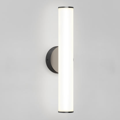The Kalio Indoor LED Wall Sconce 18" features a modern cylindrical white sconce mounted vertically on a round matte black base, shown against a plain light gray background. Suitable for 0-10V dimming and 120-277V voltage.