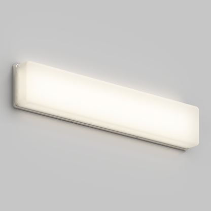 The Aster 27in Energy Star LED Vanity Light is a modern, rectangular wall-mounted fixture with a frosted cover, casting a soft white glow on a light gray background.
