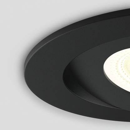 Close-up of the Skyview 4in Gimbal Round, 5CCT LED—modern round recessed light with black trim and bright textured bulb with adjustable color temperature—partially visible against a light gray background.