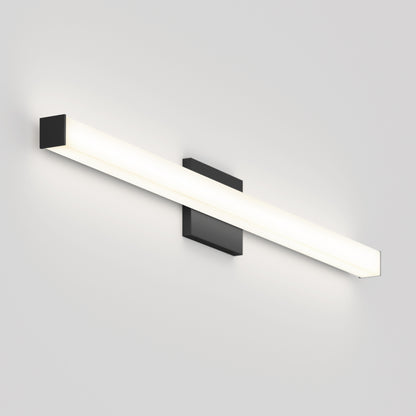 The Mylo LED Vanity Light 36IN is a modern wall-mounted fixture with a black base and long horizontal white tube, emitting soft white light against a plain light gray wall.
