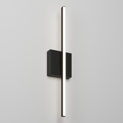 The Delta LED Indoor/Outdoor Wall Light 21'' is a modern vertical wall sconce featuring a slim illuminated light bar on a rectangular black base, perfect for adding style to any plain white wall.