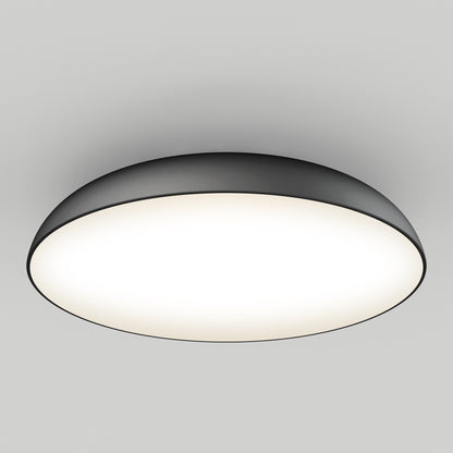 The Flint LED Flush Mount is a modern, circular ceiling light featuring a black rim and a white glowing center, installed on a plain white ceiling.