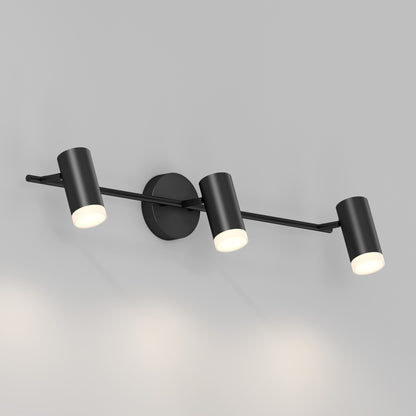 The 32" Blake 3L tracklight features three adjustable cylindrical black LED spotlights on a horizontal bar, mounted to a light grey wall, delivering versatile soft white task lighting in a modern design.