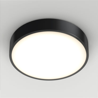 The Concerto LED Flush Mount features a modern round design with a black frame and a bright white illuminated center, installed on a plain white ceiling.