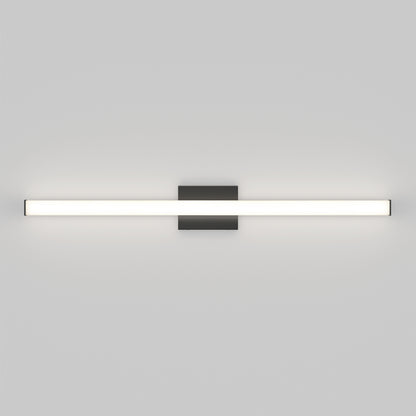 The Mylo LED Vanity Light 36IN is a modern wall-mounted fixture featuring a long, horizontal illuminated bar attached to a central rectangular black base on a plain white wall.