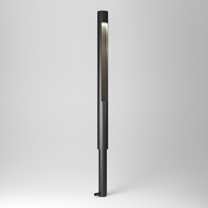 The Dark Sky Pro LED Outdoor Pathway Light Stick features a sleek black, slim cylindrical design with a vertical vent strip near the top, emitting soft white light against a plain light gray background.