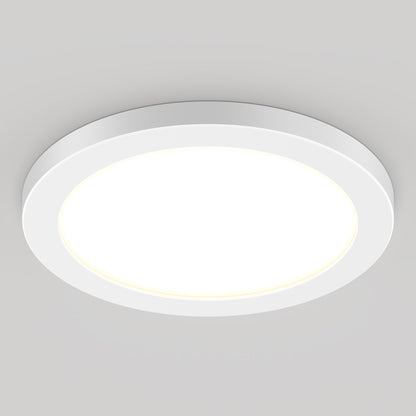The 9" LED Skylight with 3 colour trim rings features a modern, round design and adjustable colour-balance, shining brightly against a light gray ceiling.