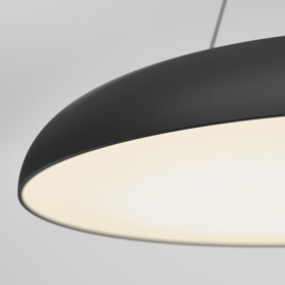 A close-up of the Flint LED Pendant, a modern black dome-shaped hanging lamp with bright white light, suspended from the ceiling against a plain gray background.