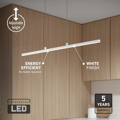 The Delta LED Linear Pendant 36IN, with adjustable height, hangs above a modern kitchen counter with wooden cabinets. Featuring energy efficiency, a white finish, and backed by a 5-year warranty.