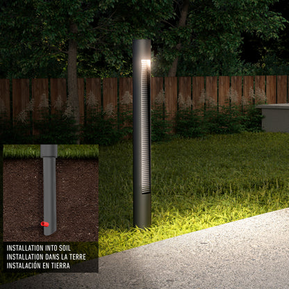The Dark Sky Pro LED Outdoor Pathway Light Stick brightens a garden at night, shown with grass and a wooden fence. An inset displays its soil installation, labeled in English, French, and Spanish.