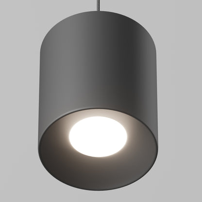 A close-up of the Beam Pro 6 Integrated LED 2-IN-1 Ceiling Mount Pendant, a modern cylindrical black light fixture with a bright bulb, hanging from the ceiling against a plain gray background.
