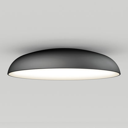 The Flint LED Flush Mount features a modern dome shape with a black exterior and a bright white underside, illuminating any plain white ceiling.
