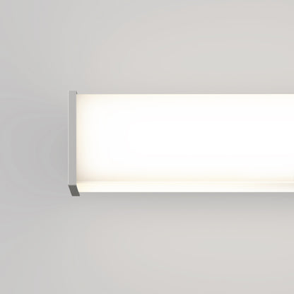 The Mylo LED Vanity Light 16IN, with metal end caps, emits a soft white glow and is mounted on a smooth light gray wall.
