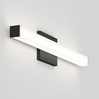 The Mylo LED Vanity Light 24IN features a sleek black rectangular base and a long horizontal frosted light bar, creating a soft white glow on any light-colored wall.