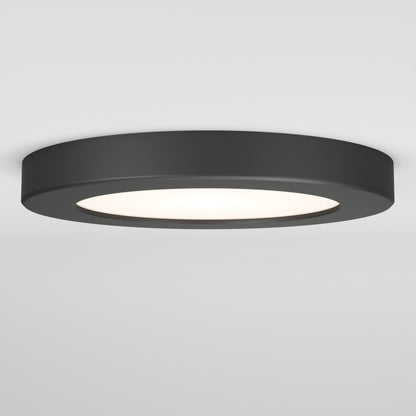 The Skylight Pro 5 3K LED Flat Panel Light is a modern, ultra-slim round black ceiling fixture with a wide flat design and white illuminated center, shown mounted on a plain white ceiling.
