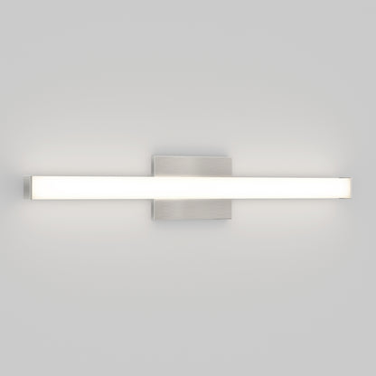 The Mylo LED Vanity Light 24IN features a rectangular brushed metal base and a long frosted glass bar that emits soft white light, elegantly wall-mounted against a plain light gray background.