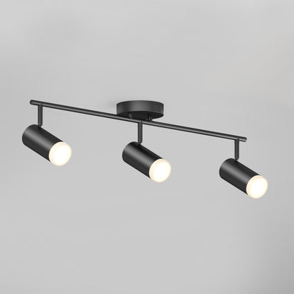 The 32" Blake 3L tracklight features three black cylindrical adjustable LED spotlights on a horizontal bar, all illuminated against a plain light gray background for effective task lighting.