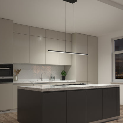 Modern kitchen with sleek beige cabinets, a marble island with black base, under-cabinet lighting, Delta LED Linear Pendant 36IN above, built-in oven, sink, potted plant; window reveals a nighttime city skyline.