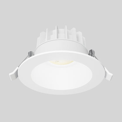 The Skyview 4in Regressed Round, 5CCT LED is a white indoor/outdoor recessed downlight with circular trim, heat sink fins, and two spring clips per side, featuring a recessed diffuser. Shown isolated on a light gray background.