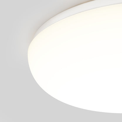 A close-up of the Knox LED 13In Energy Star Flush Mount, a round modern ceiling light fixture, glowing brightly against a plain light gray background.