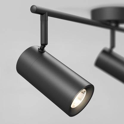 A close-up of the Alpha LED Track 3-Light, a modern black cylindrical fixture with lit bulbs, mounted on a horizontal rail against a neutral background.