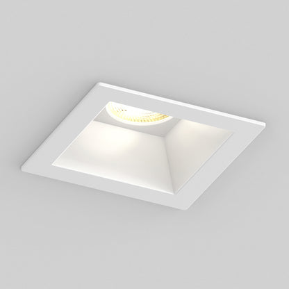 The Skyview 4in Regressed Square, 5CCT LED is a modern, square recessed pot light with a white frame, adjustable colour temperature, and visible bulb in a slanted cavity, mounted on a smooth light gray ceiling.