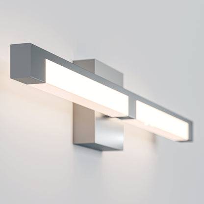 The Tivoli 27'' Vanity Light is a modern, rectangular wall-mounted LED fixture with a silver metallic finish, casting bright white light onto a plain light-colored wall.