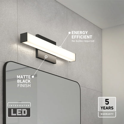 The Mylo LED Vanity Light 16IN, finished in matte black, is mounted above a minimalist bathroom mirror. Text highlights its energy efficiency, integrated LED technology, and a 5-year warranty.