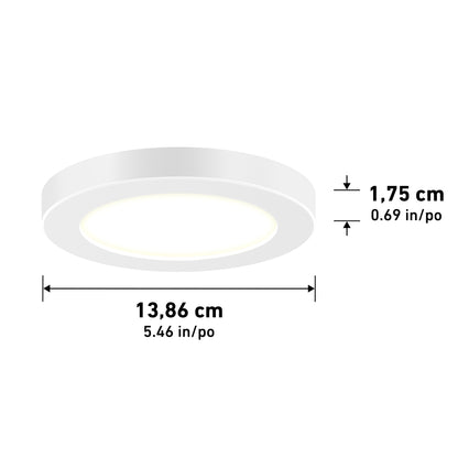 The 5" LED Skylight with 3 colour trim rings is a round, white ceiling light measuring 13.86 cm (5.46 in) in diameter and 1.75 cm (0.69 in) in height.