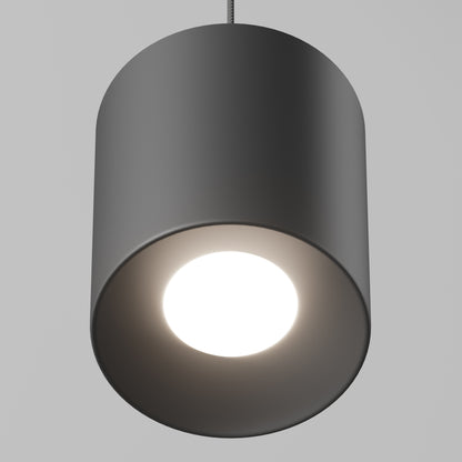A close-up of the Beam Pro 8 Integrated LED 2-IN-1 Ceiling Mount Pendant, a modern cylindrical black light, hangs from the ceiling and emits a bright white glow against a plain light gray background.