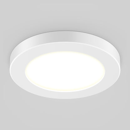 The 5" LED Skylight with 3 colour trim rings is illuminated, casting light against a plain, light gray ceiling.