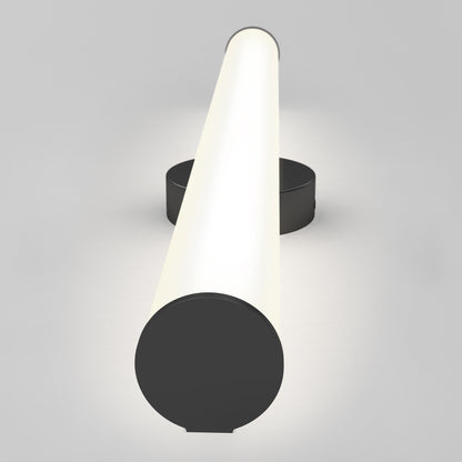 The Kalio Indoor LED Wall Sconce 32" (0-10V, 120-277V) with a black circular base is mounted on a light gray wall, casting a soft, warm glow. The photo shows the fixture lengthwise from the front.