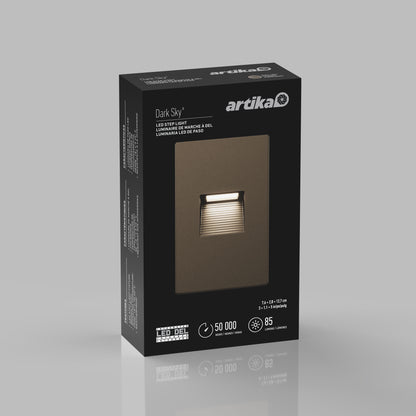 A black Artika box displays the Dark Sky LED Step Light in bronze, highlighting its 50,000-hour lifespan, 85 lumens output, and weather-resistant design.