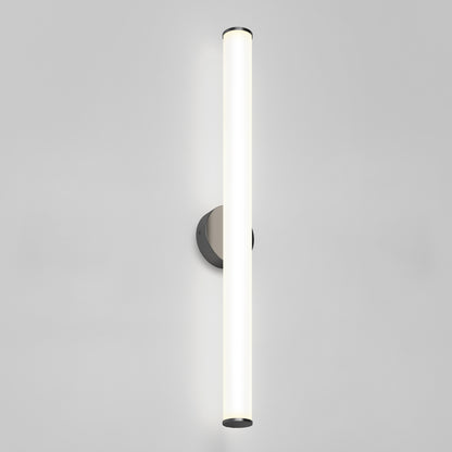 The Kalio Indoor LED Wall Sconce 32", featuring a cylindrical frosted glass tube and round metal base, emits a soft, even glow and is shown illuminated against a plain light gray background.