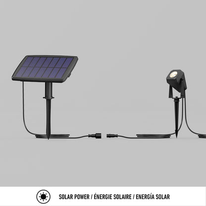 The Verner - Solar Landscape Single CCT LED 4-pack features solar-powered outdoor spotlights connected to a solar panel by a cable, displayed on a plain gray background with the caption Solar Power / Énergie Solaire / Energía Solar below.