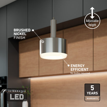 The Fritz Mini LED Pendant, featuring a brushed nickel finish, hangs in a kitchen with light wood cabinets and dark walls. Its adjustable height, tunable color temperature, energy efficiency, and 5-year warranty are highlighted in the text.