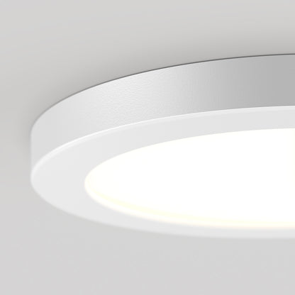 Close-up of a 7" LED Skylight with 3 colour trim rings, illuminated and mounted on a smooth white ceiling.