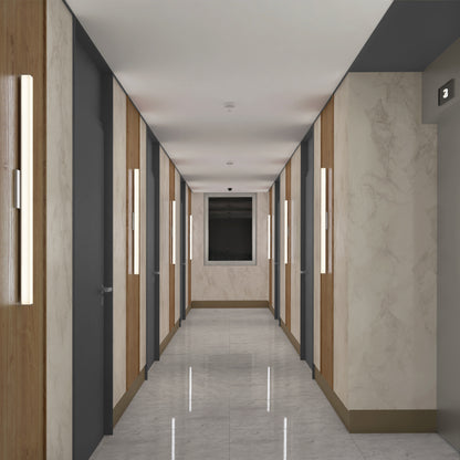 A modern hallway features marble walls, wooden accents, shiny floors, closed gray doors, and a far-end window. The space is illuminated by the Mylo LED Vanity Light 36IN above a visible number 3 sign.