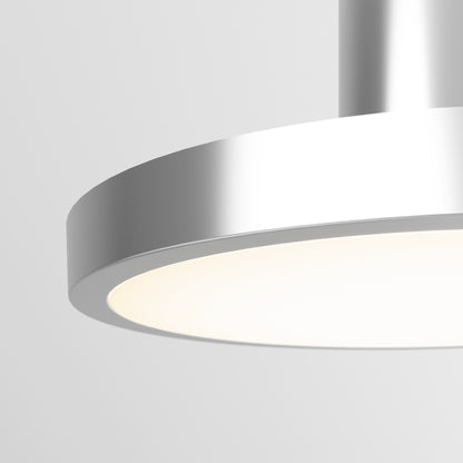 A close-up of the Romeo 1-Light LED Pendant, featuring a sleek circular design and metallic silver finish, softly glowing against a plain light gray background.