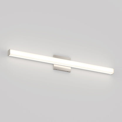The Mylo LED Vanity Light 36IN features a modern, rectangular design with a brushed metal base and a long, slim illuminated bar mounted horizontally on a plain white wall.
