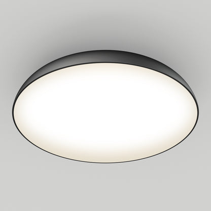 The Flint LED Flush Mount features a modern round design with a black rim and bright white center, seamlessly mounted on a smooth white ceiling.