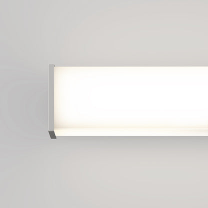 The Mylo LED Vanity Light 36IN, with its minimalist rectangular design, glows brightly against a light gray wall. Only part of the fixture is shown, emphasizing its modern and clean lines.