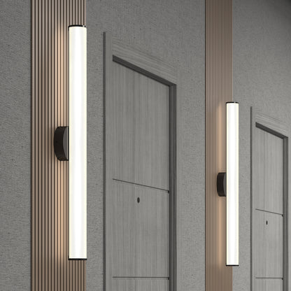 Modern hallway with light gray doors, vertical wooden slats, and Kalio Indoor LED Wall Sconce 32" fixtures emitting soft white light. The minimalist, contemporary design emphasizes clean lines and neutral tones.