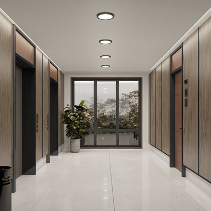 A hallway with wood doors, a plant, and a 9" LED Skylight with 3 colour trim rings provides adjustable lighting for the perfect ambiance.