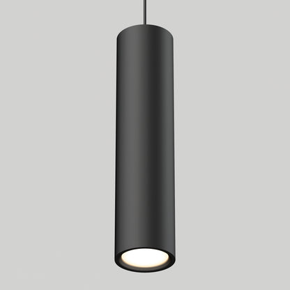 The Damian LED Cylinder Pendant, a modern black fixture, hangs from the ceiling and emits a soft white glow from its open bottom against a plain light gray background.
